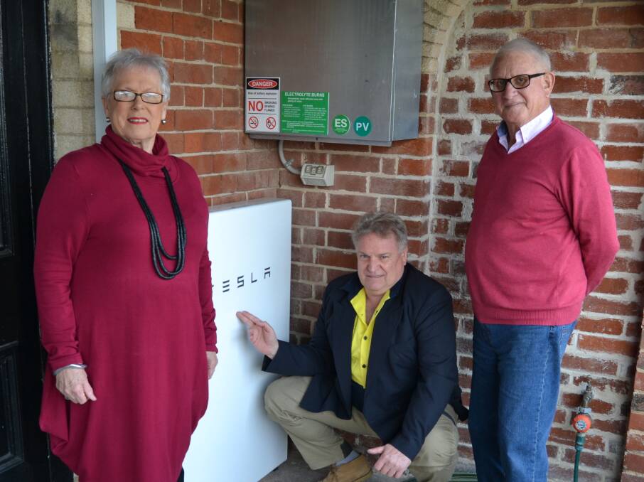 MONEY SAVER: Monica Morse, Rural Green Energy director Darryl Leahey and Michael Morse, with the Morses' newly installed Tesla Powerwall. Photo: BRADLEY JURD