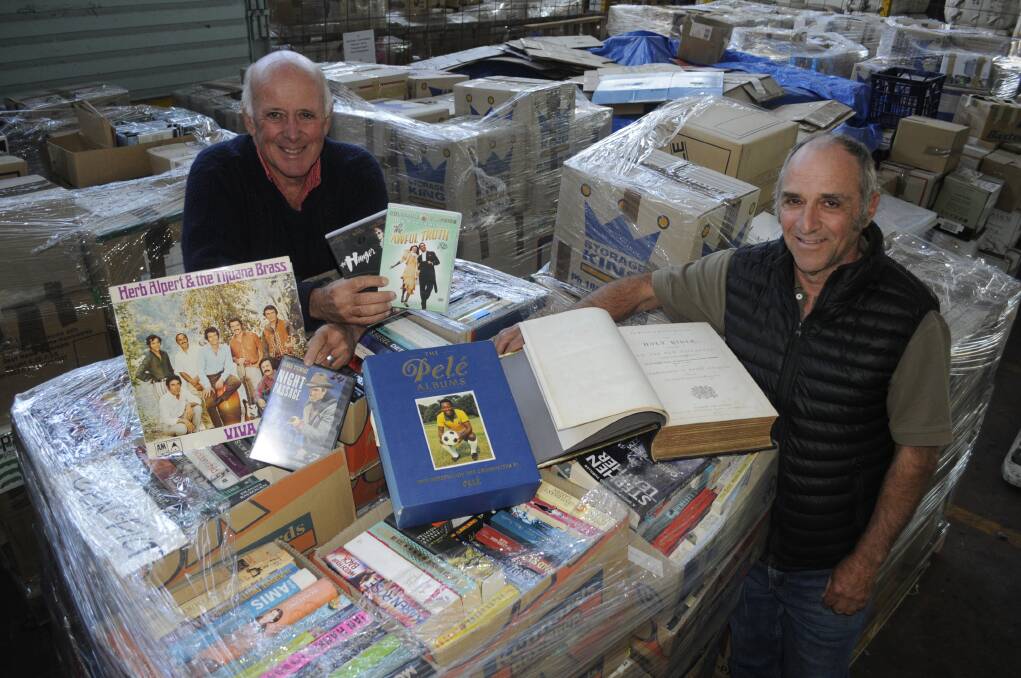 BOOKS GALORE: Lifeline Central executive officer Alex Ferguson and chairman Bill Miller, with books, CDs and DVDs for this weekend's Lifeline Central West Book Fair. 