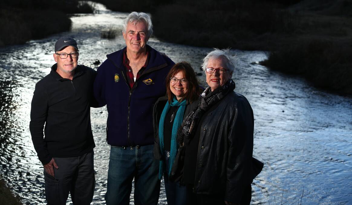 THE RIVER RUNS: David Abernethy, John Fry, Tracy Sorensen and Bathurst councillor Monica Morse celebrate beside the Macquarie River on Wednesday. Photo: PHIL BLATCH