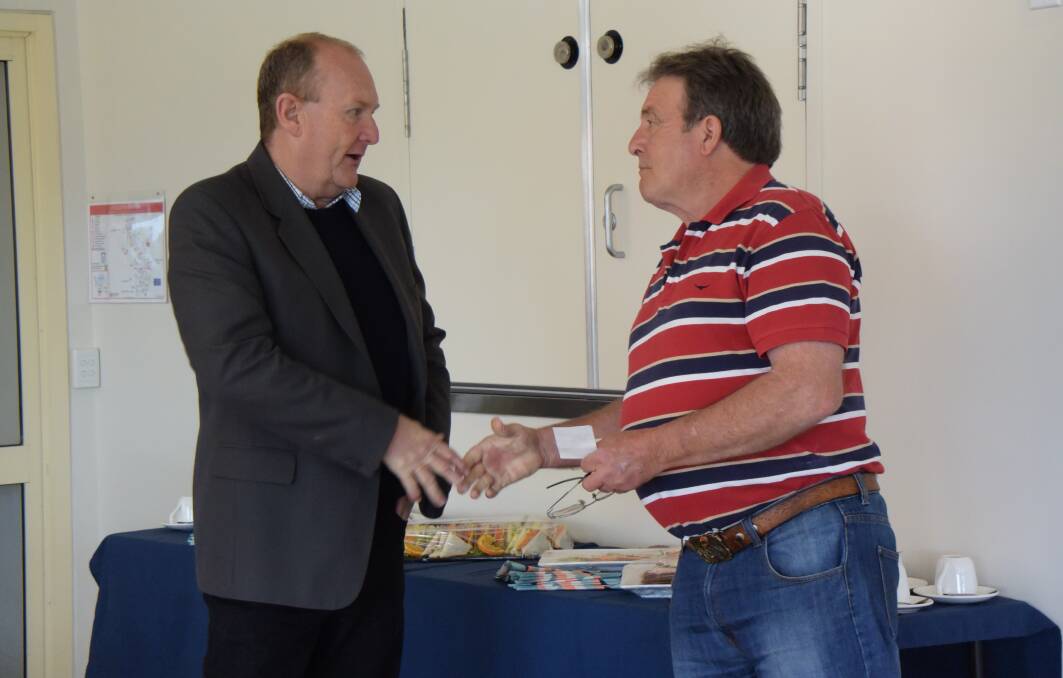 GIFT: Phil Paton hands over the $8,600 cheque to Garry Brown at Three Tree Lodge in Lithgow. Picture: PHOEBE MOLONEY. 