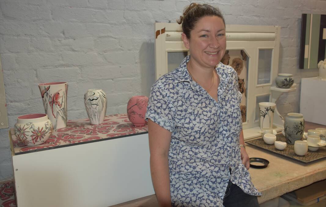 WORKS OF ART: Sarah O'Sullivan with some of her ceramics displayed in the store of the Lithgow Pottery. Picture: PHOEBE MOLONEY. 