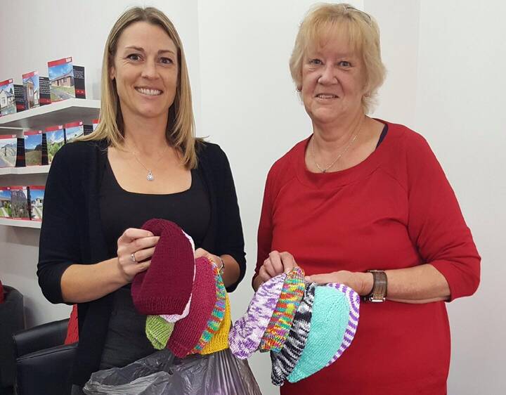 BEANIES FOR RESEARCH: Christine Dodson with Chris Nothey who has knitted and donated 24 beanies for the ball. 