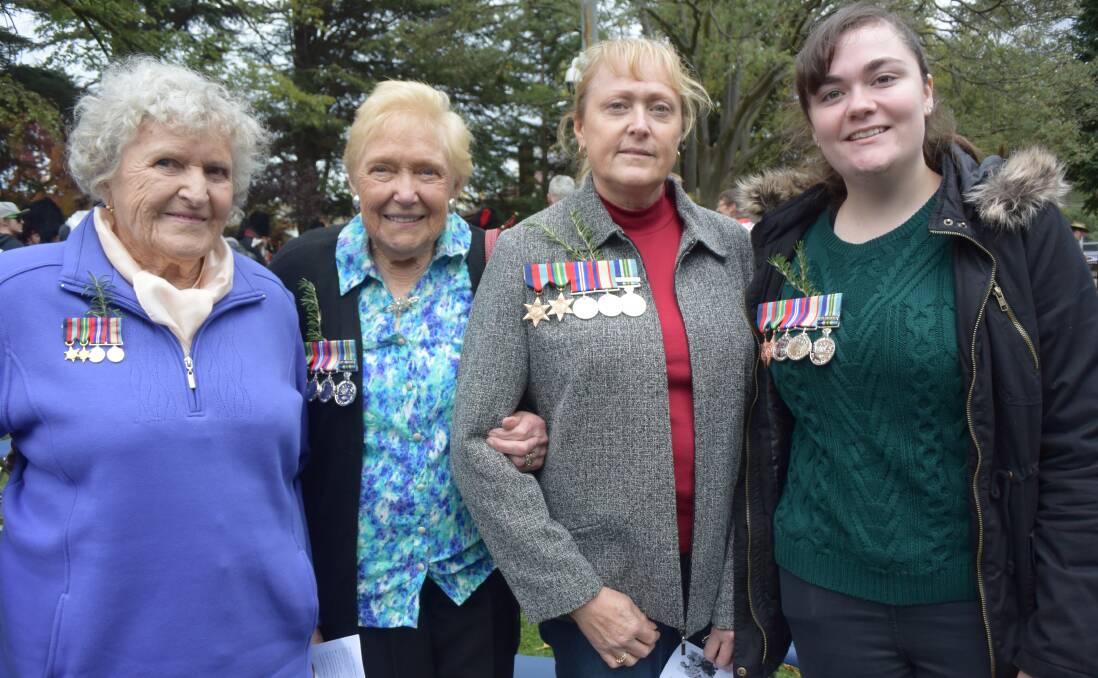 NOW WE REMEMBER THEM: Sisters Mai Waddell and Nell Dowler wear the medals of their late husbands. Mr Dowler is represented by three generations including his daughter Jenny Brown and granddaughter Emma Brown.