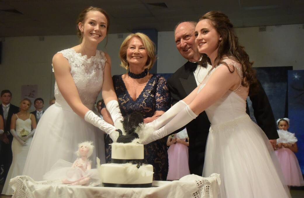 TAKING THE CAKE: Debutantes Paige McNamara and Amy Thompson cut the cake with Matron of Honour Gloria Cooper and guest of honour Terry Fitzpatrick at the 2017 ball. Picture: KIRSTY HORTON. 