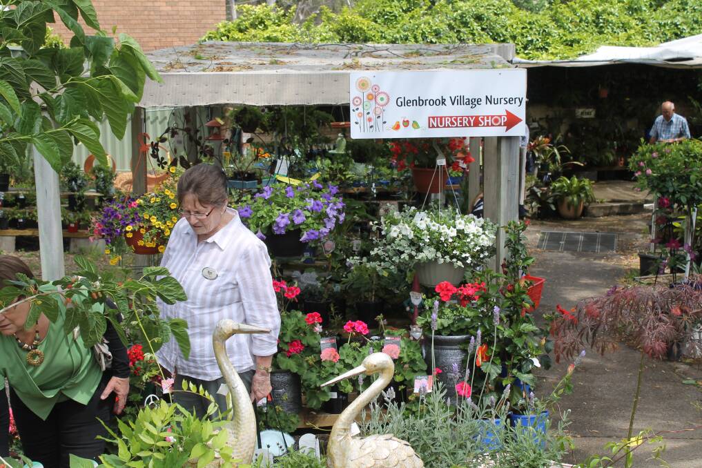 OUTING: Grace Cuthbert admiring the plants at the Glenbrook Village Nursery. Picture: SUPPLIED. 