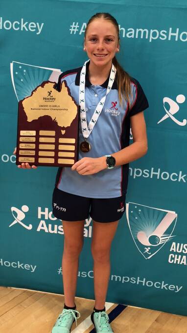 GOLDEN GIRL: Emily Thompson with the indoor hockey championships trophy and the gold medal she won for NSW. Picture: SUPPLIED. 
