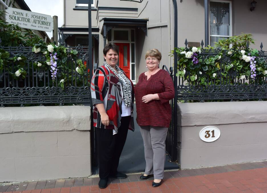 STREET OF FLOWERS: Jacki Mitchell and Glenda Anthes of WILD show their civic pride with the organisation's flower displays on Main Street. Picture: PHOEBE MOLONEY