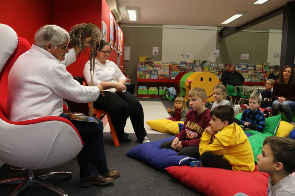 LEARNING: Aunty Helen Riley shows children a traditional emu feather headdress at Lithgow Library's NAIDOC storytime last year. 