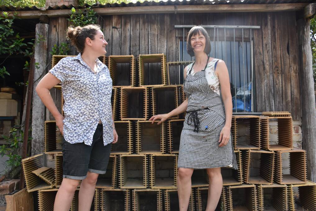 TILE SETTERS: Artists Sarah O'Sullivan and Jacqueline Spedding stand in front of old tile setters used at the Lithgow Pottery. Picture: PHOEBE MOLONEY. 