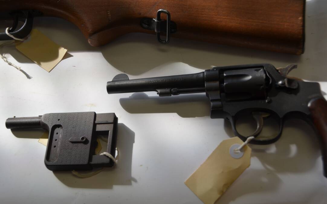 CURIOUS: A tiny palm gun and a revolver from WW2 handed in during the amnesty. 