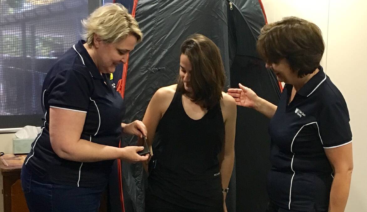 SKIN DEEP: CSU researchers Dr Tamara Cumming (left) and Associate Professor Sandie Wong (right) with a research assistant modelling the Hexoskin.