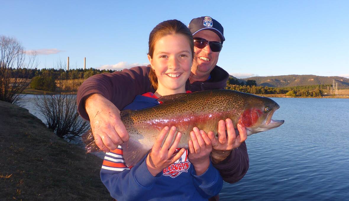 SEVEN-POUND WHOPPER FROM RELEASE: Sophie Lane holds her Rainbow Trout catch with father Ben. Photo supplied.