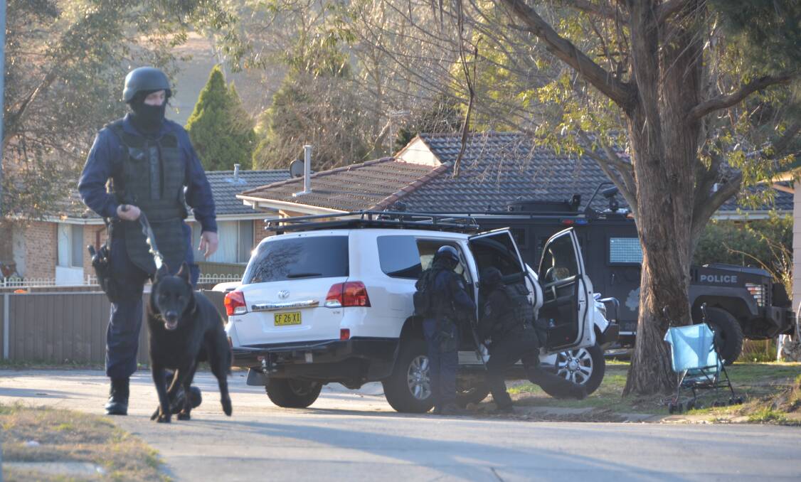SPECIALISED POLICE: The dog squad and an armoured vehicle attended the Landa Street address