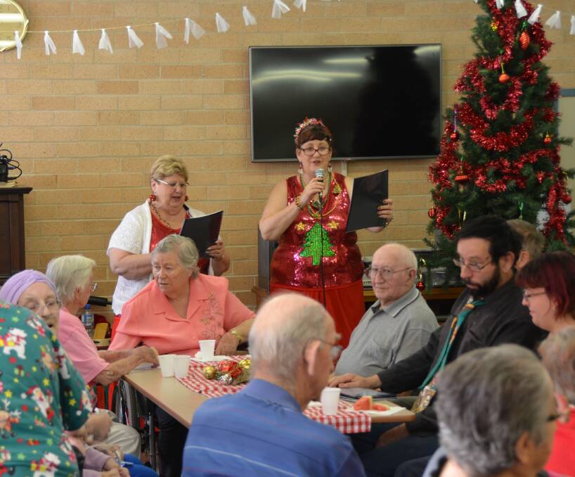 CHRISTMAS CHEER: Bev Coombs and Glenda Phipps from Them Again entertain the Lithgow Aged Care's volunteers party. Photos: Troy Walsh.