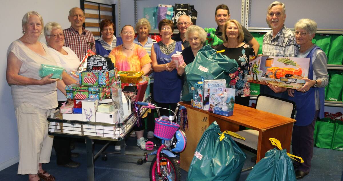 WELCOME GIFTS AT CHRISTMAS: Volunteers and staff from Lithgow St Vincent de Paul with the gift bags and food hampers they put together.