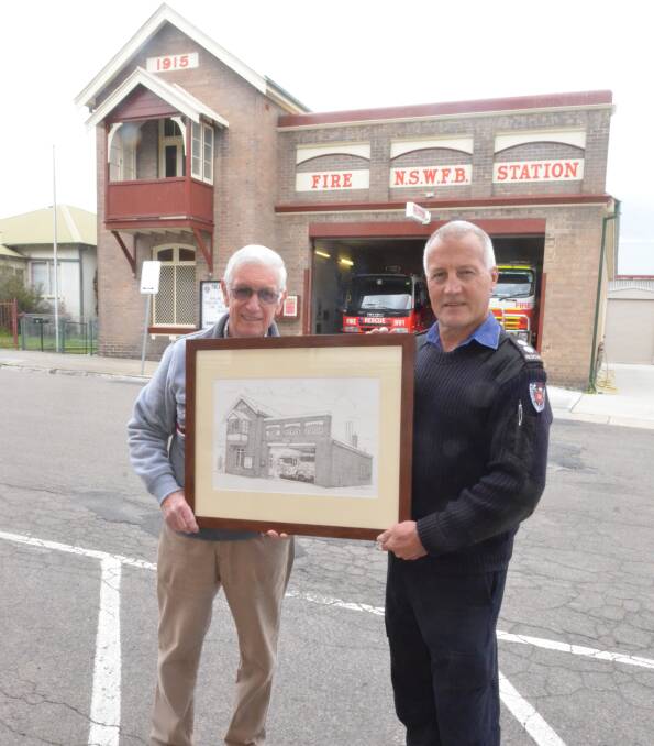 DONATION: Artist John Barnes holds the realistic drawing with Lithgow Fire and Rescue Station Officer Noel Ford. Photo: Troy Walsh.