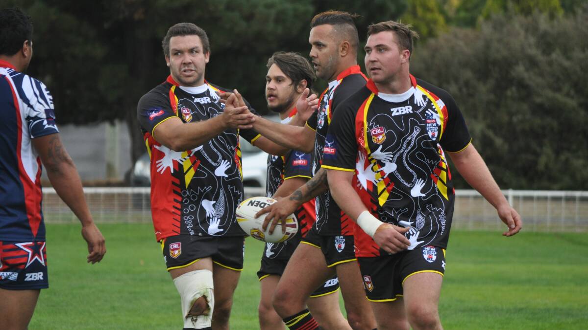 WHAT A WIN: The Indigenous boys celebrate Jeremy Gordon's try at King George Oval on Saturday. Photo: NICK McGRATH