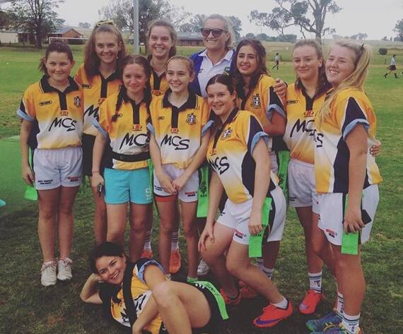 WHAT A GAME: The Molong Central School girls with Australian player Ruan Sims. Photo: CONTRIBUTED