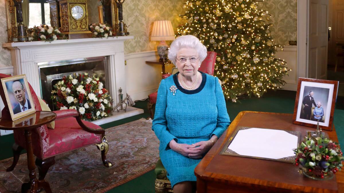 Queen Elizabeth II sits at a desk in the Regency Room after recording her Christmas Day broadcast to the Commonwealth at Buckingham Palace on December 24, 2016 in London, England. Photo: Yui Mok - WPA Pool/Getty Images