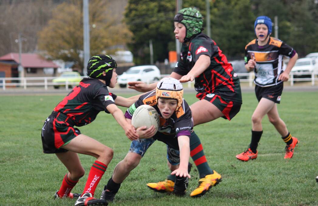 BACK TO IT: Storm's Cooper Egan (centre) will be keen to take to the field again when the junior rugby league competition resumes this weekend.