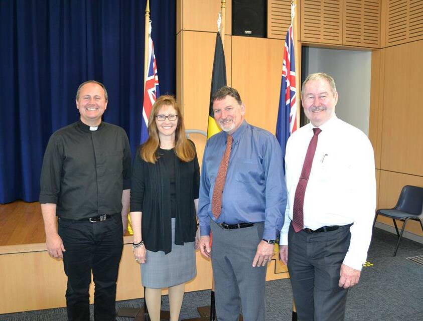 A WARM WELCOME: From left Fr Greg Bellamy, Joyce Smith, current Acting Principal Paul Menday and Vince Connor (CEO Consultant to schools). PHOTO: Supplied.