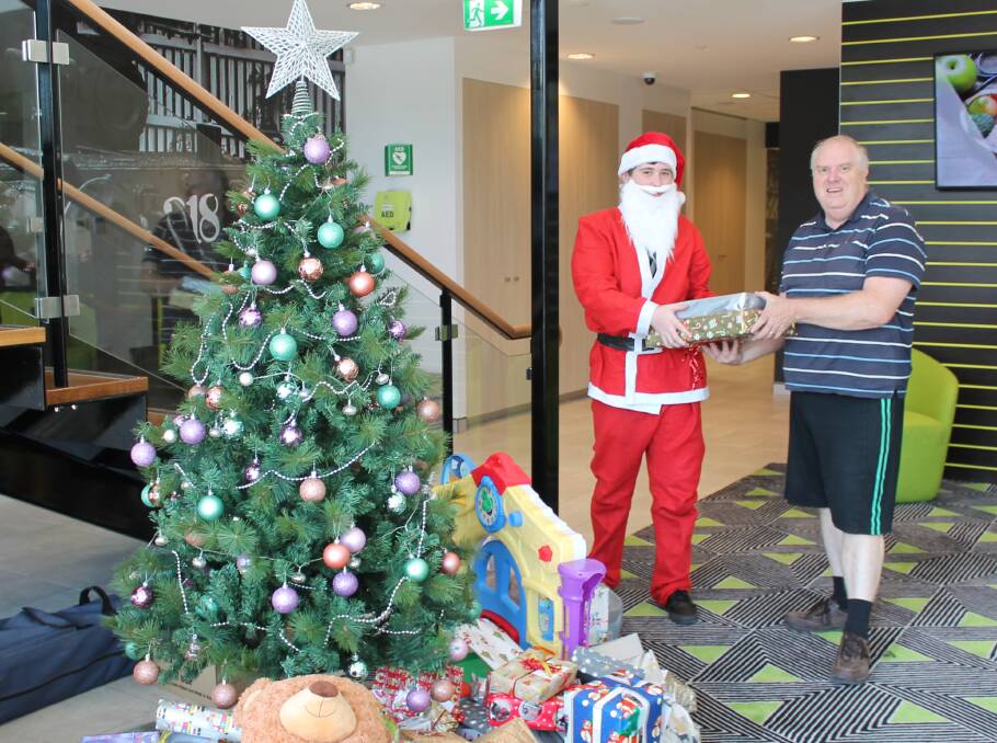 Santa was on hand to help the Westfund Health Insurance team hand over the donations. He is pictured with Christmas and Beyond's Craig Raynor.