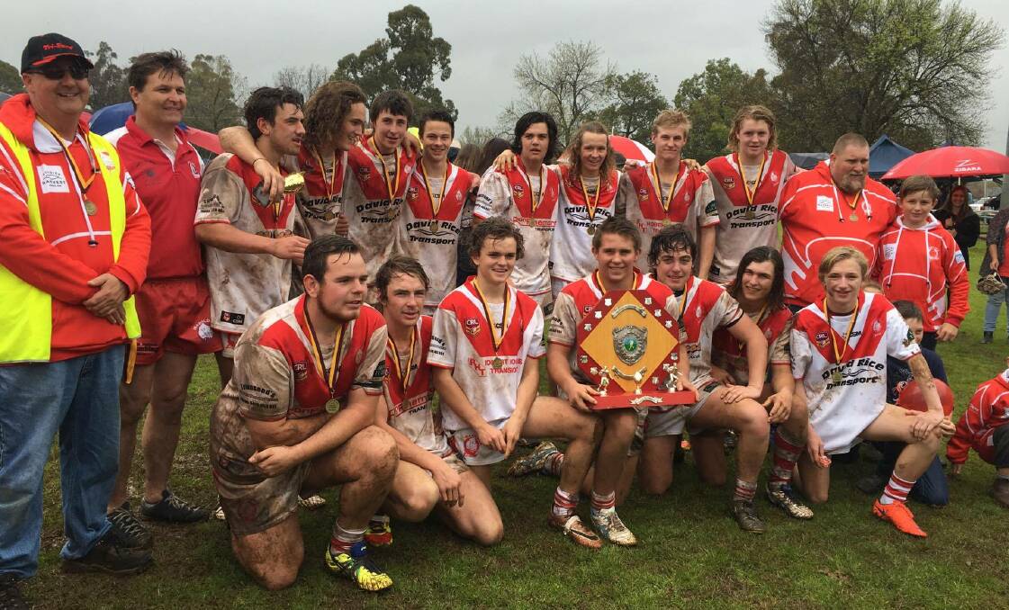MIGHTY CHARGING RHINOS: Manildra's youth league side celebrates its Woodbridge Cup grand final win. Photo: DANNIELLE GROSSMITH