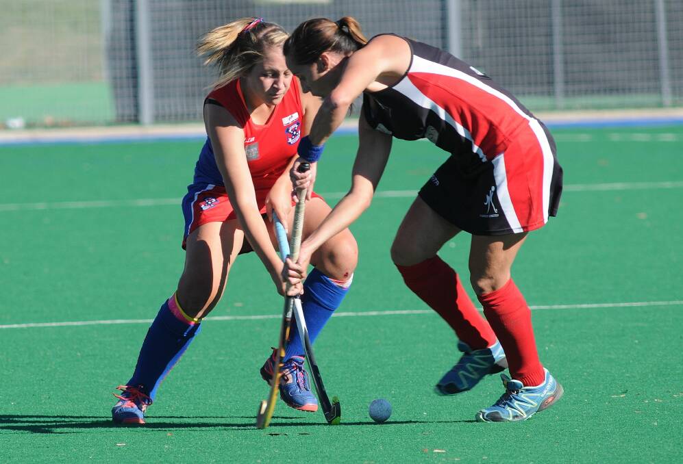 MOMENTARY LAPSES: Confederates star Tiff Davis battles with a Parkes opponent in her side's 3-1 loss to United, on the road, on Saturday. Photo: STEVE GOSCH