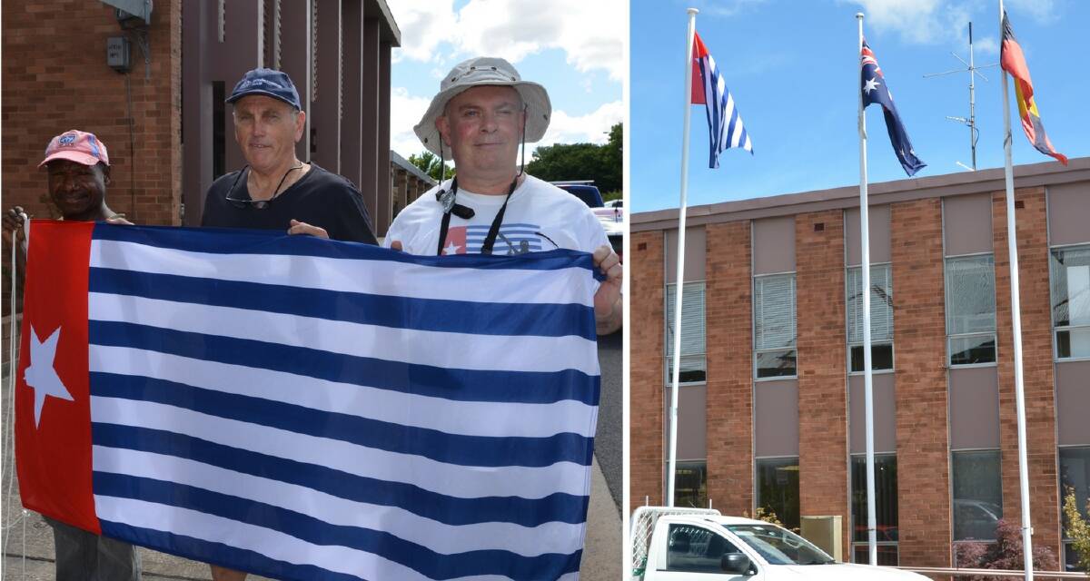 Patianus Kogoya, Roger Bowen and Lithgow's Anthony Craig with the Morning Star flag of West Papua outside the Lithgow City Council offices on Friday, December 1. Picture: HOSEA LUY
