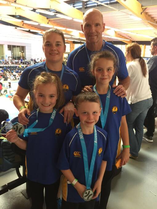 Back: Coaches Misty Walsh and Master Jeff Crane. Front: Fighters Alexis Reid, Hunter Pender and Jorja Pender. Picture: SUPPLIED