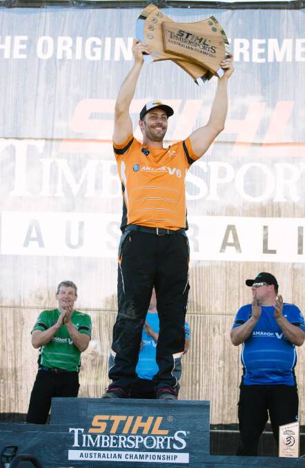 WHAT A CHAMPION: Lithgow's Brad De Losa lifting the Australian Timbersports trophy high after his win at Albert Park on Sunday. Picture: SUPPLIED