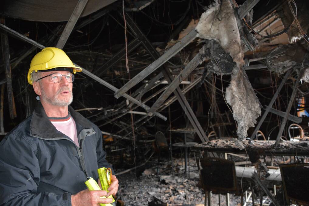 President of Katoomba All Services Club, Brian Turner, inspects fire damage to the Lurline Street club. Photos: BC Lewis