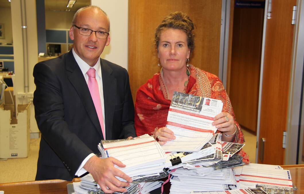 NSW Labor Opposition Leader Luke Foley with Trish Doyle in NSW Parliament lodging the petition of 10,000 signatures against the new intercity fleet train project.