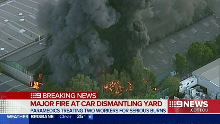 A huge plume of smoke rises from the blaze at the car wrecking yard in Revesby in Sydney's south-west. Photo: Nine News