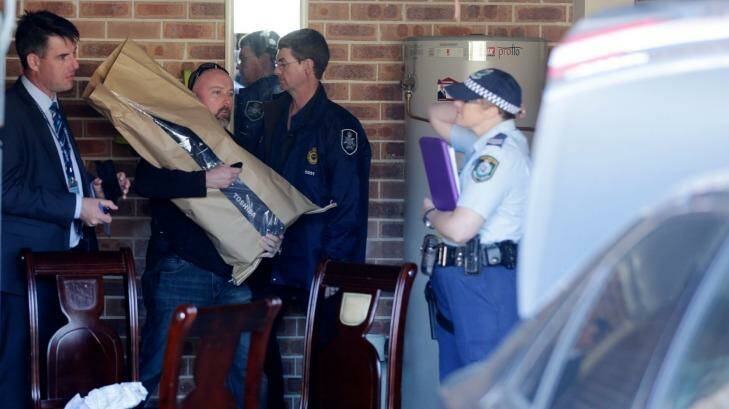 Terror raids: Heavily armed police inspect one of 25 Sydney properties. Photo: Edwina Pickles