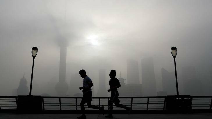 Joggers along Shanghai's famous Bund: China's pollution is on the rise. Photo: Andy Wong
