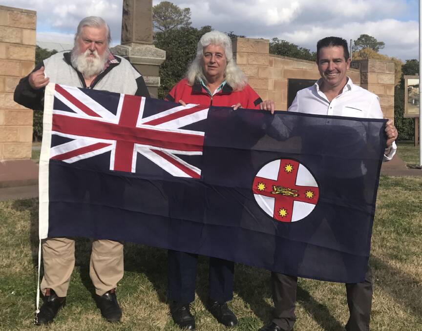 FLYING THE FLAG: Danny Whitty OAM and Robyn Whitty with the flag presented by Bathurst MP Paul Toole to the Wallerawang War Memorial Committee. Picture: SUPPLIED. 