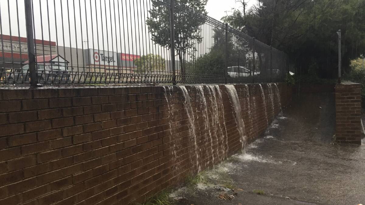 Water cascaded and pooled around the Lithgow Plaza Centre car park last night. It was not the only place around Lithgow to experience large pools of water forming. 
