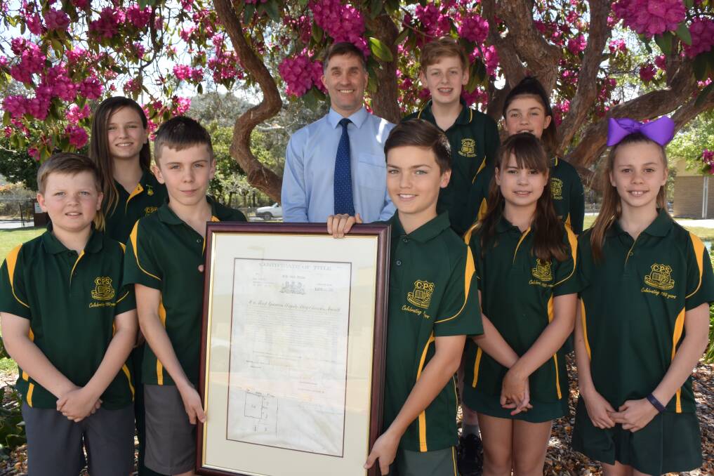 LEADERS: Cooerwull Public School's leaders Ethan Barrett, Ella Mickleson, Max Ellery, Principal Mark Snow, Tallan Egan, Brayden Drury, Bella Nunan, Meg Carter and Jenna Sheather with the original deed for the purchase of the current primary school site in 1907. Picture: KIRSTY HORTON. 