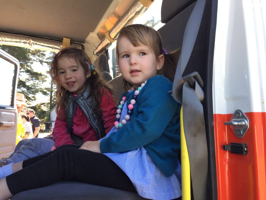 LIFE IN THE FIRE TRUCK: Mona Serves and Lilly Dever hop up in the Hartley Fire Truck. Picture: KIRSTY HORTON.