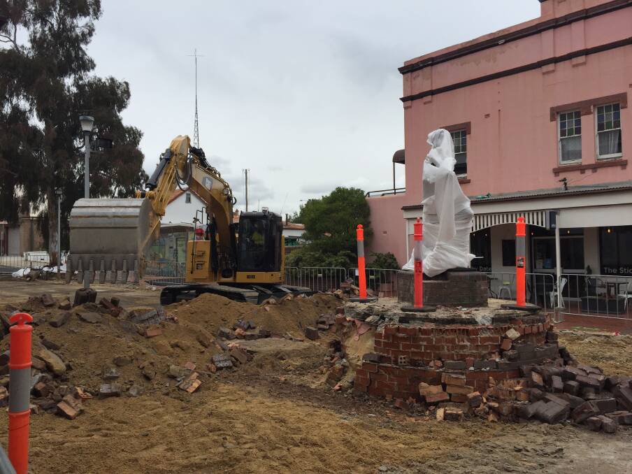 UNDER WRAPS: The statue of the Lithgow Flash, Marjorie Jackson, is carefully wrapped as work gets under way at the Cook Street Plaza. Picture: KIRSTY HORTON. 