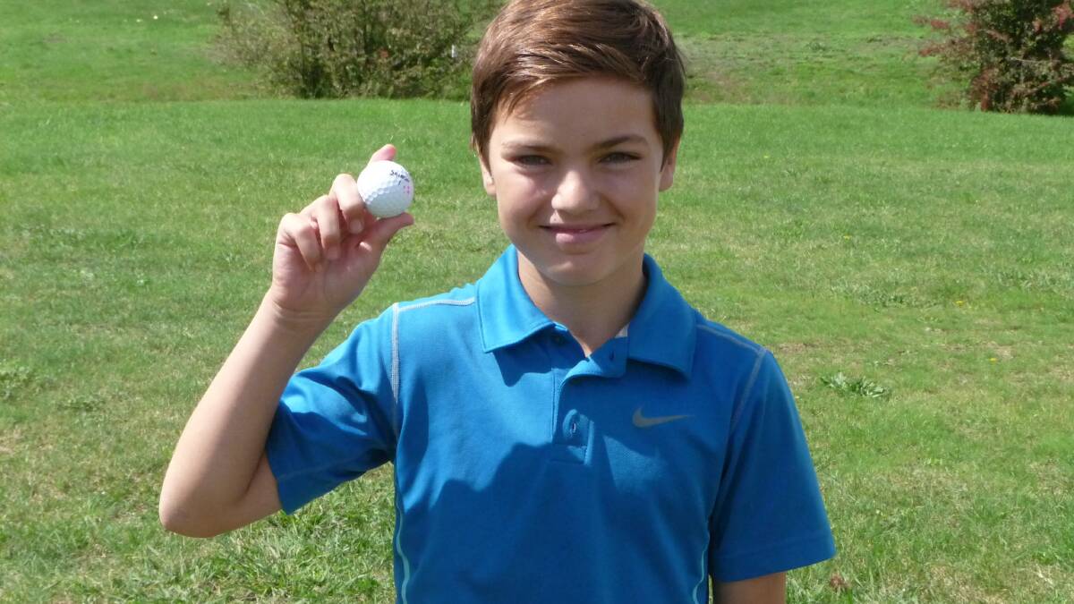 TOP SHOT: 11 year old Tallon Egan with his hole-in-one ball at Lithgow Golf Club. Picture: SUPPLIED. 