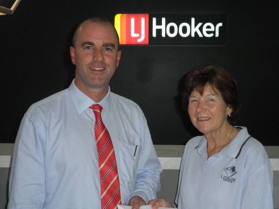 SUPPORTER: Ladies President Judi Moore accepts a sponsorship cheque from Jamie Giokaris of LJ Hooker.