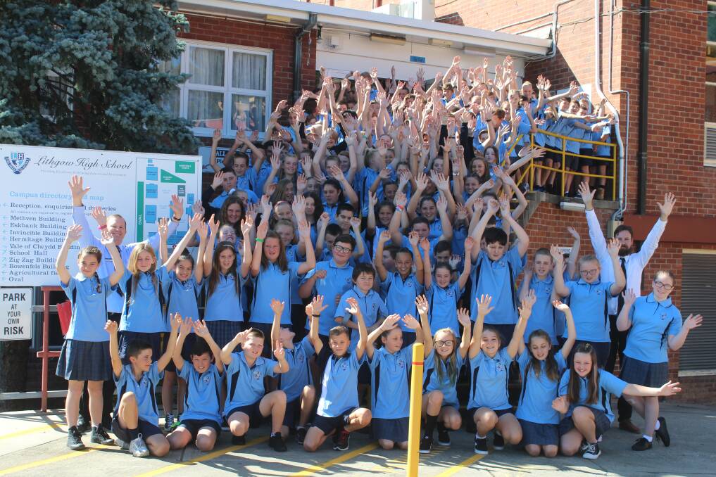 HANDS IN THE AIR: It was a happy start for the new Year 7 class. 