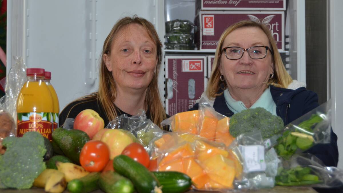 FRESH FOOD SUNDAYS: St Paul's Anglican Church members Peta O'Meley and Corrine Ogg with a small sample of the food available. Pictures: HOSEA LUY. 