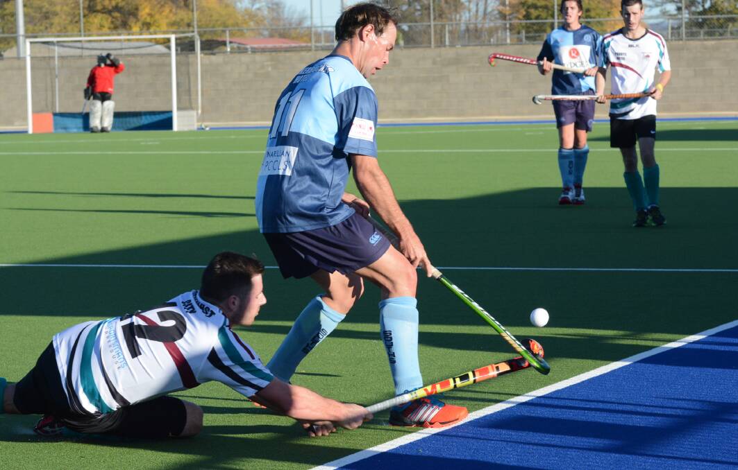 INCOMING: Souths' Dylan Smith watches out for a diving Blake Davis of Bathurst City during the first men's Premier League Hockey match between the two sides. Souths recorded a 5-1 win. Photo: PHILL MURRAY 052315psouths9