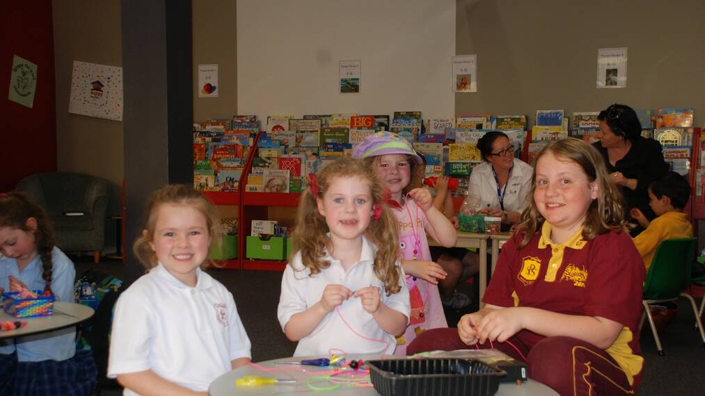 THOUGHTFUL GIFTS: St Patrick’s Primary School students Abigail Long, Dia MacNamara, Molly Drengenberg and Gwendolyn Long hard at work. 	lm101014library