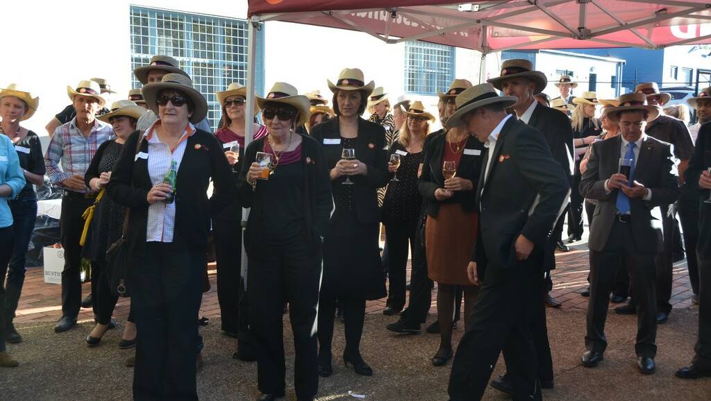 A DUAL PROMOTION: Souvenir straw hats with the Westfund logo helped keep the hot afternoon sun from guests who gathered in the courtyard for an open air ceremony making the completion of a $1.5 million refurbishment of Westfund’s Railway Parade headquarters. 
lm101314LA0903
