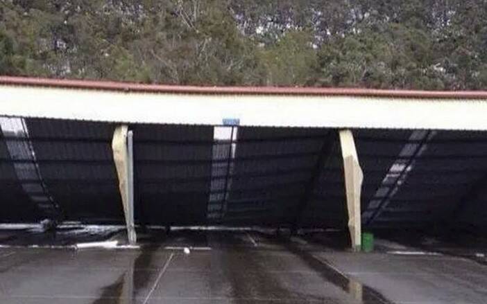 MORE THAN IT COULD CARRY: A large awning covering the play area at Lithgow High School could not bear the load of the snow. 	lm101814damage