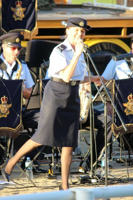 IN FULL SWING: The RAAF band was not all instrumental, this songstress had the crowd moving. 